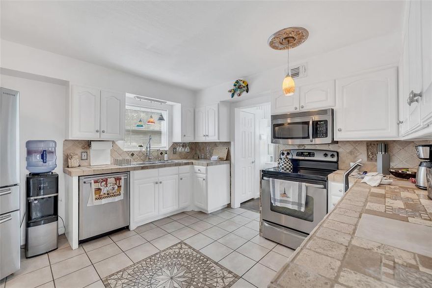 Welcome to your private oasis! 3-homes! The main house is an updated 4-bedroom, 2-bath single-family home that seamlessly blends modern convenience with timeless charm. From the moment you step inside, you’re greeted by abundant natural light and an inviting atmosphere perfect for both relaxing and entertaining. The spacious downstairs primary suite and thoughtfully designed kitchen both open directly to a stunning backyard retreat—complete with a sparkling pool, flagstone patio bench, and covered lounge area ideal for outdoor dining or sunset cocktails. It’s the ultimate space to unwind after a long day. Beyond the main residence, a separate structure offers two fully equipped units, each with private entrances—perfect for generating rental income, housing guests, or creating the ultimate home office or studio. Gated parking provides security and ease for both the main home and accessory units. Modern updates include stainless steel appliances, and tasteful touches that preserve the home's original character. This is more than just a home—it's a lifestyle.
Don't miss the chance to own this unique, income-producing property with resort-style amenities.