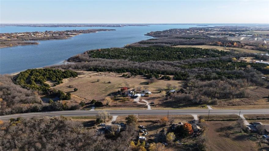Magnificent incredible property that backs up to the Corps of Engineers land overlooking Lake Lavon. ±7.66 acres with a main house and 3 cabins or tiny homes that are all very nicely finished out, and could be income producing rentals. Property is currently used as residential but has tremendous commercial or development potential. The property is in the county and removed from the ETJ, however if a developer decides to bring in sewer from one of the nearby developments, then it would need to annex into the city. This is the last property on the left when leaving the peninsula. It would be ideal for a retail center or a mixed use type development. Perhaps homes, townhomes or apartments overlooking the lake in back. It is truly a unique offering and rare opportunity. Just minutes to major shopping in Allen and McKinney. About 20 minutes to Hwy 75 or about 10 minutes to 380 in Princeton. Walmart is about 10 minutes away in Lucas. Buyer to verify all information.