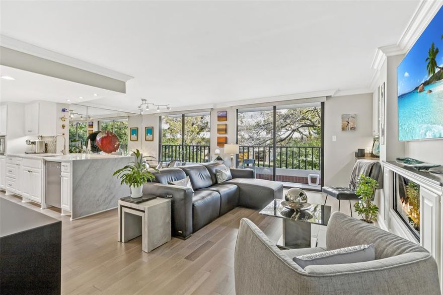 Ideally situated along iconic Turtle Creek Boulevard, this beautifully updated 2-bedroom, 2-bath residence at The Beverly offers refined, lock-and-leave living in one of Dallas’s most desirable boutique condominium communities.
This north-facing home is filled with natural light and features wood floors throughout, an electric fireplace, and an open-concept layout designed for comfortable living and effortless entertaining. The living and dining areas open to a private terrace with peaceful treetop views, creating a serene indoor-outdoor retreat. A custom bar with beverage refrigerator adds the perfect touch for hosting and everyday enjoyment.
The kitchen and baths have been thoughtfully updated with elegant marble countertops and timeless finishes. The spacious primary suite serves as a true sanctuary, featuring a wall of custom closets and a built-in workspace, and is highlighted by a spa-inspired bath with double vanity, shower, and freestanding soaking tub. The secondary bedroom includes a custom closet, built-in workspace, additional storage, and a Murphy bed, offering exceptional flexibility for guests, a home office, or multi-purpose living. Additional highlights include a utility closet with stackable washer and dryer, two assigned parking spaces, private storage unit, and generous in-home storage throughout.
The Beverly is an exclusive 40-unit, full-service midrise offering 24-hour security and concierge service, a resort-style pool, fitness center, and secure parking. The recently renovated lobby and owners’ lounge showcase stunning high-end designer finishes and artwork, elevating the building’s already sophisticated atmosphere. HOA include water, sewer, trash, and building maintenance, basic cable and centralized hot water, providing exceptional convenience and a truly low-maintenance lifestyle.
Just minutes from Katy Trail, Uptown, Highland Park, and the Arts District, this residence delivers the perfect blend of luxury, privacy, & accessibility.