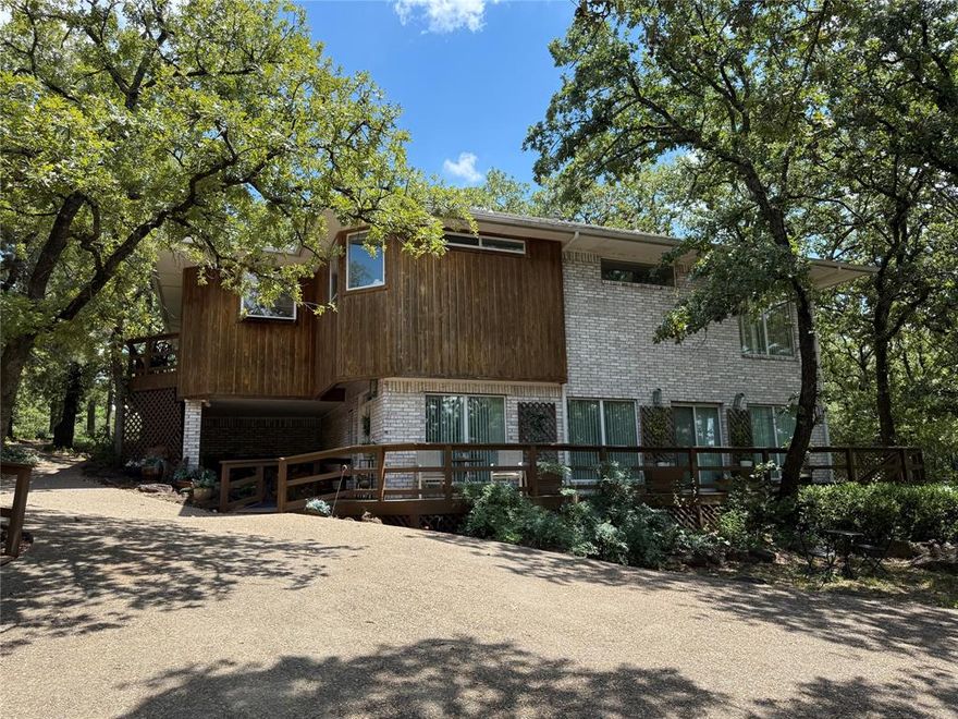 Great opportunity to see what the Lake Kiowa community is all about! This home is located on the 6th fairway on over a half acre lot. Loads of windows provide natural light and beautiful views from every room. The home is furnished and has all appliances.  The large primary suite has a large cedar closet and a great en suite bathroom with loads of light, separate vanities, a soaking tub and separate shower.  The secondary bedrooms are located on the bottom floor. They share a Jack and Jill bathroom and a small kitchenette with sink, small refrigerator, and microwave. The detached garage features a second floor office or flex room that is a great place to work or enjoy privacy from the rest of the home.