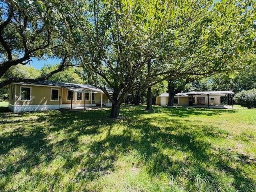 This charming 3-bedroom, 2-bath home sits on over 2 acres of land in Kemp, TX, offering the perfect blend of comfort and privacy. The home boasts split bedrooms, a spacious living and dining area, a convenient laundry room, and a relaxing back patio. Additional features include a 2-car carport, a versatile 1-bedroom, 1-bath efficiency ideal for a home office or guest suite, and a storage building. Surrounded by tall Texas trees, the property offers natural shade, walking trails, and a wet-weather creek that adds a touch of tranquility. Please note part of the land lies in a flood zone near the creek. Conveniently located near HWY 175, in Kaufman County, and within Kemp ISD. Seller may offer financing options with a substantial down payment (OAC).