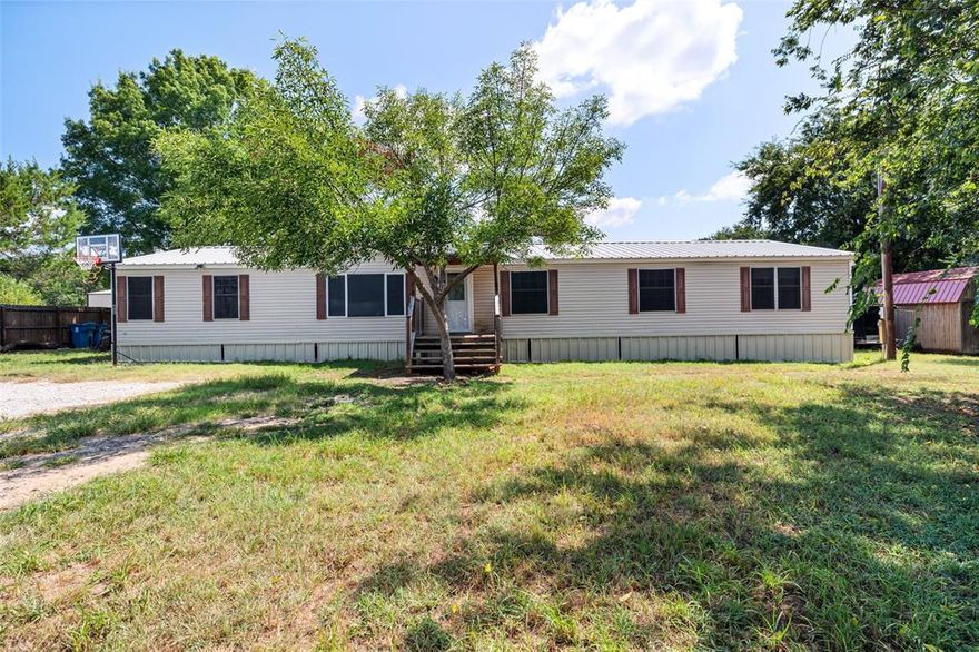 THIS 2356 sq ft AMAZING PROPERTY IS in a great lake community. Come check out this one as it wont last for long. Settled in FAMOUS Lake Granbury where everyone wants to live because Granbury is so great! This 4 bdrm MH will not disappoint, with the .6 acres fully fenced with an electric privacy gate, and a partial Three quarter view fence. Step into this wonderful spacious home, with a very large kitchen and dining area, Gorgeous professionally coated countertops, coated Cutlery kitchen Island and a huge family room at the back of the home. Very well insulated with R30 insulation under the floor and vapor barrier. Plumbing is all pex & CPVC, was replaced before my client purchased the property. skirting completely replace with wood frame & lots of screened metal ventilation made with with wood and steel. Brdrms are spacious and very nice. The yard is amazing, lots of gorgeous trees when you need to stay in the shade, and also has a workshop storage building. Community Amenities Clubhouse, swimming pool, boat launch, and fishing dock  On-site Sky Harbor Fire Department Low HOA fees with minimal restrictions. This property is a true gem, very well maintained, and it is just minutes from everything including downtown Granbury Town Square where there is always alot going on. Granbury is a wonderful town, where you can shop at the famous HEB, Kroger, Walmart, and the very cool Brookshires where they will still take your groceries to your car. a Brand new Costco is only approx. 30 minutes away in Weatherford TX , Lots of Restaurants, shops and so much to do in our quaint little town.