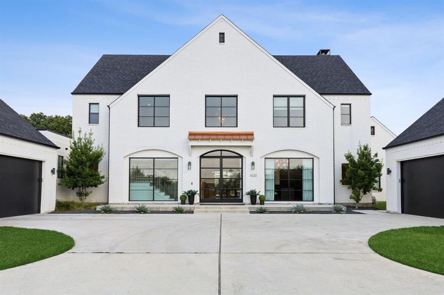 Positioned at the highest point in the coveted Hat Creek Estates, this masterpiece sitting on 2 acres offers unmatched views and elevated living in one of Argyle’s most elite neighborhoods. Designed by architect Luis Olivares and crafted by Axiom Home Builders in 2021, this home combines timeless elegance with modern comfort and high-end functionality. Enjoy panoramic views that stretch across the lush treed greenbelt in the back and a tranquil waterfall pond in the front - creating a serene and picture-perfect setting every single day. Surrounded by multi-million dollar estates, this property is right at home among Argyle’s finest. Inside, the open-concept floor plan is a true entertainer’s dream. The chef’s kitchen features commercial-grade appliances, a spacious butler’s pantry, and flows effortlessly into the dining space and expansive living area. Thoughtfully designed details include self-closing drawers and cabinetry, and a full-home custom audio and visual system with centralized controls. Step outside to your covered patio complete with outdoor kitchen and fireplace, ideal for year-round gatherings. Enjoy your private resort-style oasis featuring an 8-foot deep, heated pool with integrated spa, synthetic turf, and a custom putting green. Additional highlights include custom designed window treatments, an oversized 4-car garage and zoning to top-rated Argyle ISD, with Liberty Christian School just minutes away. This is true country estate living with urban convenience - Target, Whole Foods, and other amenities are all within 15 minutes.