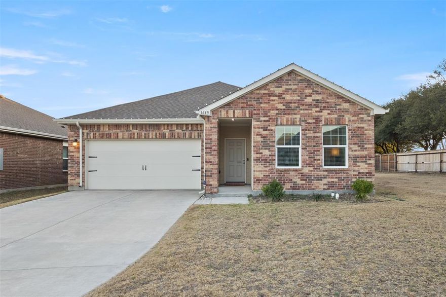 Welcome to this beautifully maintained 1-story corner-lot home offering 1,805 sq ft of thoughtfully designed living space in a quiet, growing Haslet community. Built in 2021, this 3-bedroom, 2-bath home is a rare find, featuring a covered backyard patio included in the original build, added privacy from its corner-lot location, and no homes directly behind.

The open-concept layout is ideal for both everyday living and entertaining, with durable laminate vinyl wood-style flooring throughout the main living areas. The kitchen serves as the heart of the home and features a large kitchen island designed for both seating and food preparation, along with ample counter space and seamless flow into the living area. A designated dining area offers flexibility and can easily function as a work-from-home space or home office.

High-end ceiling fans are installed in the primary bathroom and on the covered backyard patio, enhancing comfort indoors and out. Custom blinds are installed on all windows, providing privacy and a polished finish throughout the home. Additional highlights include a front-facing 2-car garage and modern finishes.

The seller is open to negotiating the inclusion of select appliances, including a KitchenAid refrigerator and commercial-grade washer and dryer, adding extra value and convenience.

Located within Northwest ISD and managed by an HOA, the neighborhood offers a peaceful setting with exciting growth ahead, including the anticipated new Haslet city library. Conveniently located near Texas Motor Speedway, Buc-ee’s, Tanger Outlets, and approximately 30 minutes from downtown Fort Worth.

Ideal for first-time buyers, downsizers, growing families, or investors (subject to HOA and city guidelines), this corner-lot home offers privacy, flexibility, and modern comfort in a rapidly growing area.