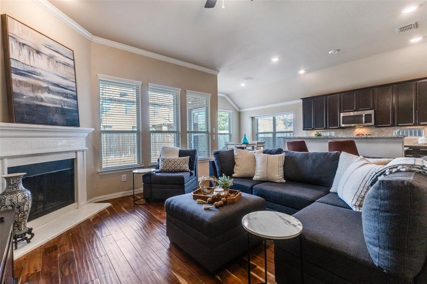 Charming single-story home in a fantastic neighborhood with outstanding community features, zoned to highly desirable Prosper ISD. This open-concept floor plan showcases a spacious living room with a cozy fireplace, seamlessly connected to a well-appointed kitchen featuring a large island and gas cooktop — ideal for everyday living and entertaining. A private study with French doors is thoughtfully positioned at the front of the home, perfect for working from home. The dining room offers generous space to host family and friends. Tucked away at the back of the home, the primary suite provides a relaxing retreat with an ensuite bath complete with a soaking tub, oversized shower, and walk-in closet. Recent updates include brick flower beds, a new front door, updated lighting, and an entry ramp for easier access to the front porch. Additional highlights include engineered wood flooring, neutral tones throughout, and a covered patio for outdoor enjoyment. Located in Prestwyck, residents enjoy access to a 17-acre city park with a splash pad, playground, zip line, and walking trails, along with a community pool, basketball courts, and scenic pavilion. Conveniently close to medical centers, shopping, and just a short drive to historic downtown McKinney Square.