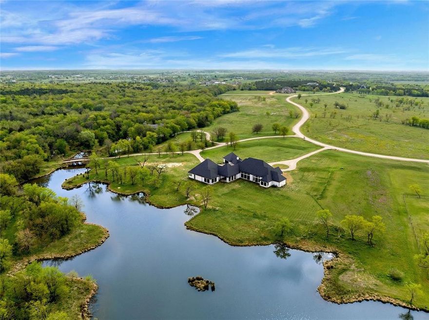 Seller is offering a $25,000 Credit to Buyer with acceptable offer to be used towards closing costs or interest rate buy down. Exceptional custom-built estate located in a private gated community in Rockwall County. Situated on a beautiful 2.13-acre lakefront homesite, this impressive single-level home offers 5,695 square feet of thoughtfully designed living space combining luxury, comfort, and functionality.The home features 4 spacious bedrooms, each with its own ensuite bathroom, for a total of 5 full baths and 2 half baths to accommodate family and guests. Designed for both everyday living and entertaining, the layout includes two expansive living areas, a formal dining room, and two fireplaces that create warm, inviting gathering spaces throughout the home. The oversized 4+ car garage provides ample space for vehicles, storage, or hobbies. The primary suite is a true retreat featuring his and hers walk-in closets and a spa-inspired bathroom. Additional highlights include a secure safe room, walk-in attic storage, security cameras and energy-efficient spray foam insulation. Step outside to enjoy the covered patio overlooking the peaceful lake and wide-open acreage, offering the perfect setting for outdoor living and entertaining. This rare one-level luxury property provides privacy, space, and scenic surroundings while still being conveniently located near the amenities of Rockwall County