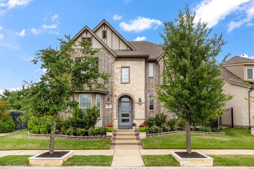 Welcome to a renovated home where timeless architecture meets modern luxury and thoughtful design.
From the moment you arrive, the striking brick and stone façade, arched entry, and lush landscaping set an impressive tone. Inside, soaring ceilings, rich hardwood floors, and a sweeping curved staircase create a grand yet inviting first impression.
Designed for both everyday living and effortless entertaining, the light-filled open-concept living area showcases a dramatic floor-to-ceiling fireplace and seamless flow into a stunning chef’s kitchen. Here, you’ll find a statement quartz waterfall island, custom cabinetry, Signature collection stainless steel appliances with commercial grade range and vent hood, convection microwave -with built in air fryer- and oven, designer lighting, and a spacious walk-in pantry—equal parts beauty and function. The dining area has a dry bar with under cabinet lighting and extra storage, perfect for a coffee bar. 
A dedicated home office with custom built-ins offers a polished and productive workspace, while the upper level features a versatile game room and a true media room, perfect for movie nights and gatherings.
The expansive primary suite is a private retreat, featuring vaulted ceilings, abundant natural light, and a spa-inspired ensuite with a freestanding soaking tub, oversized shower, separate vanities, and walk in closet.
Every detail has been thoughtfully curated—from stylish finishes and abundant storage to a well-appointed laundry room with room for stacked washer and dryer, water filter and softener, to a 3 car garage with extra storage space—creating a home that is as functional as it is beautiful.