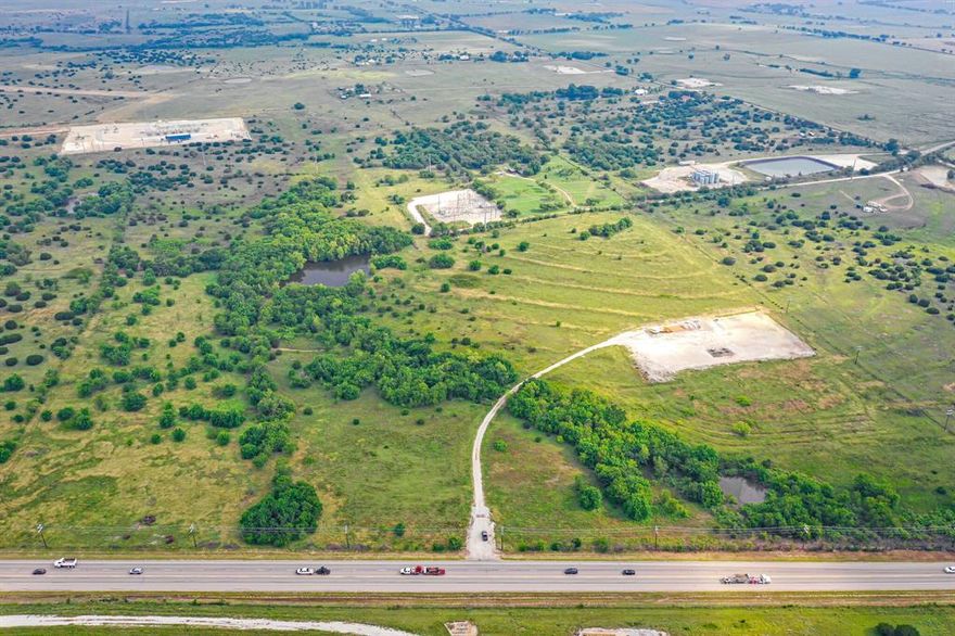 Centrally located only 9 miles from Chisholm Trail Parkway, this large property spans 134 acres right off of Highway 67 with 2800ft of property line meeting the frontage road. Property features agriculture, wildlife, 3 ponds, sprawling open field, as well as, more densely treed area. Multiple property access points make it prime for development as does it's proximity to the frontage road. Level elevations span the highway while the property is higher in the back.