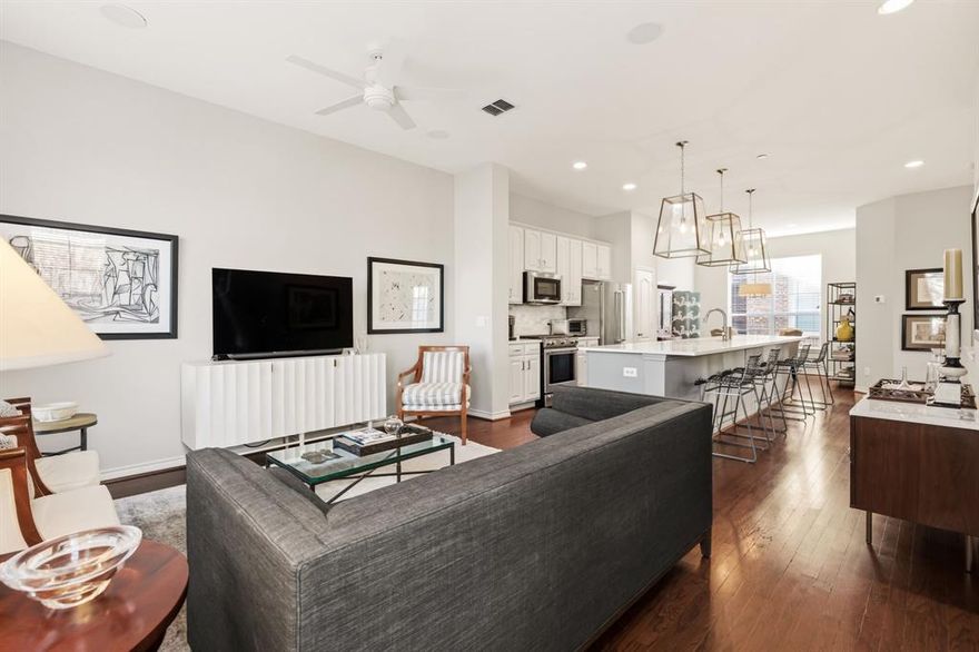 Perfectly located three-story end-unit condo features an open-concept layout filled with natural light, recessed lighting, and gleaming hardwood floors. The first level offers a guest bedroom with an ensuite bath and walk-in closet, along with an attached two-car garage. The second floor is designed for entertaining, showcasing a spacious updated kitchen with a large quartz island, gorgeous lighting and Kitchen Aid appliances, a dining area, living room, powder bath, and private balcony. Upstairs, the oversized primary suite includes an ensuite bath with dual vanities, a soaking tub, separate shower, and an expansive walk-in closet, plus an additional private balcony. Ideally located in the coveted Knox Henderson neighborhood just steps from the Katy Trail, this sleek condo provides walkable access to some of Dallas’ best shopping, dining, and entertainment.