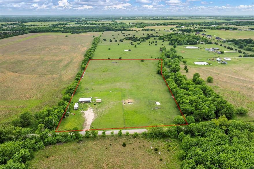Skip the waitlists for meters and the headaches of clearing land—your Texas homestead is already established and ready for you on day one. Nestled on 10 sprawling, ag-exempt acres in Greenville, this fully fenced and cross-fenced property is a rare find that blends immediate livability with endless future potential.

The property features a finished tiny home (built in 2022) offering over 900 sq ft of total living space, complete with a covered porch and wood decks, perfect for enjoying quiet country sunsets. A brand-new 120 sq ft workshop.shed (built in 2025) provides excellent storage or hobby space.

Bring your horses and livestock immediately! The pastures are lush, flat, and secured with heavy-duty wire mesh fencing, farm gates, and mature tree lines that offer incredible natural privacy and windbreaks.

Crucially, all heavy infrastructure is complete: active electric service with an on-site pole and transformer, rural water, and a lateral-line septic system are already installed. An expansive cleared pad site with utility hookups makes this the ultimate setup to live comfortably while building your custom dream home, or simply enjoy it as a low-maintenance weekend retreat.

With easy access via a well-maintained country road and a gated, unpaved driveway offering ample parking for heavy equipment and trailers, this property is a fully functional, move-in-ready slice of Texas. Don't buy raw land and wait years to use it—start living your rural dream today.