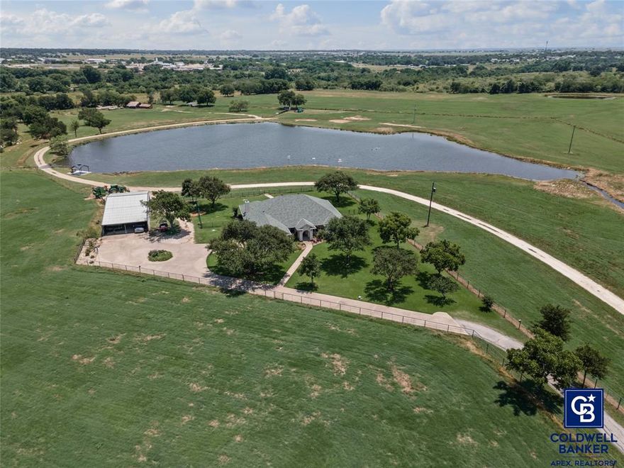 Discover the perfect blend of luxury and tranquility at this custom-built one owner home nestled on approximately 52 breathtaking acres just outside Cleburne city limits. Utilities in place on south side of pond for additional residence. Abundance of wildlife and ponds are stocked with bass and catfish. This expansive farm and ranch property offers a serene escape without sacrificing the conveniences of modern living. Step inside to a welcoming interior that features 3 spacious bedrooms, office, dining room, breakfast area, and 3 well-appointed baths. Designed with comfort and functionality in mind, the home’s generous living area is illuminated by walls of windows that frame magnificent views of a spectacular pond. The heart of the home lies in its remarkable kitchen, featuring an abundance of custom cabinets and ample countertop space to accommodate all culinary adventures. An island complements the workspace while the adjoining dining area offers a welcoming spot for gatherings. The primary suite is a private retreat featuring a luxurious ensuite bathroom with a garden tub, walk in closets, and a walk-in shower. Each of the additional bedrooms provides generous closets and space to unwind. A designated office offers the perfect spot for focused work- from -home days. Beyond the inviting interiors the property also showcases extensive exterior amenities. A large shop lends itself to numerous uses. The serene pond enhances the natural beauty of the land, creating opportunities for peaceful reflection or recreational activities. Septic, water and electric are on south side of pond for an additional residence. This is more than just a home; it’s a lifestyle waiting to be embraced. Whether you envision equestrian pursuits, farming endeavors, or simply seeking peace and privacy, this property delivers beyond expectations.