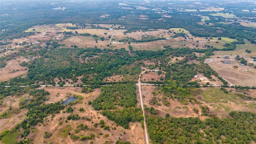 The property comes with no deed restrictions, offering a vast canvas of possibilities! There's a spacious 1800 sqft pole barn, perfect for a variety of uses. The surrounding land is a serene escape, offering plenty of room for expansion, whether you're interested in gardening, hobbies, or even raising animals. Location-wise, this property maintains an ideal balance of seclusion and accessibility. Situated just 15 minutes from Decatur, 50 minutes from Fort Worth, and 35 minutes from Denton, it allows for convenient access to city amenities while still enjoying the tranquility of rural living. This unique property is perfect for those looking for a starter project, a distinctive retreat, or a creative space that melds simplicity, freedom, and a deep connection to nature, all within easy reach of urban conveniences.