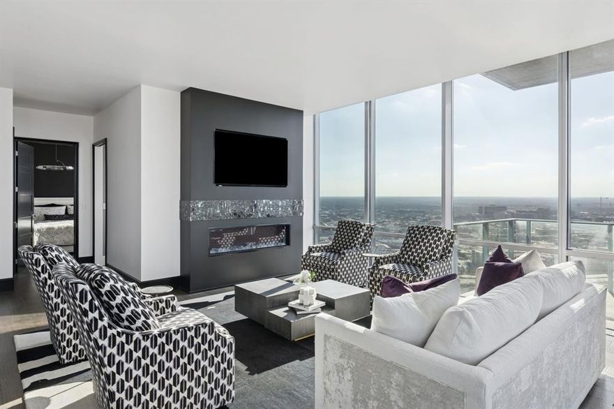 Welcome to residence #2601 at the Omni located in the heart of downtown Fort Worth. Fully re-designed in 2025, this sophisticated 2-bedroom, 2-bathroom high-rise retreat features floor-to-ceiling windows frame sweeping skyline views stretching as far as the eye can see, while a wraparound balcony creates effortless indoor-outdoor living. Inside, an open-concept layout is anchored by a chef’s kitchen with waterfall marble countertops, Monogram and KitchenAid appliances, and a seamless flow into the living and dining spaces. The primary suite is a private sanctuary with a spa-inspired bathroom, dual vanities and walk in shower, while the guest bedroom offers comfort for visitors or could be used as an in home office space. Residents enjoy 24-hour concierge service, a resort-style pool, and a state-of-the-art fitness center. Alll just steps from Fort Worth’s best dining, entertainment, and culture. Private Omni Residents receive additional Omni perks, as well as a Black Level membership with Omni Hotels and Resorts.