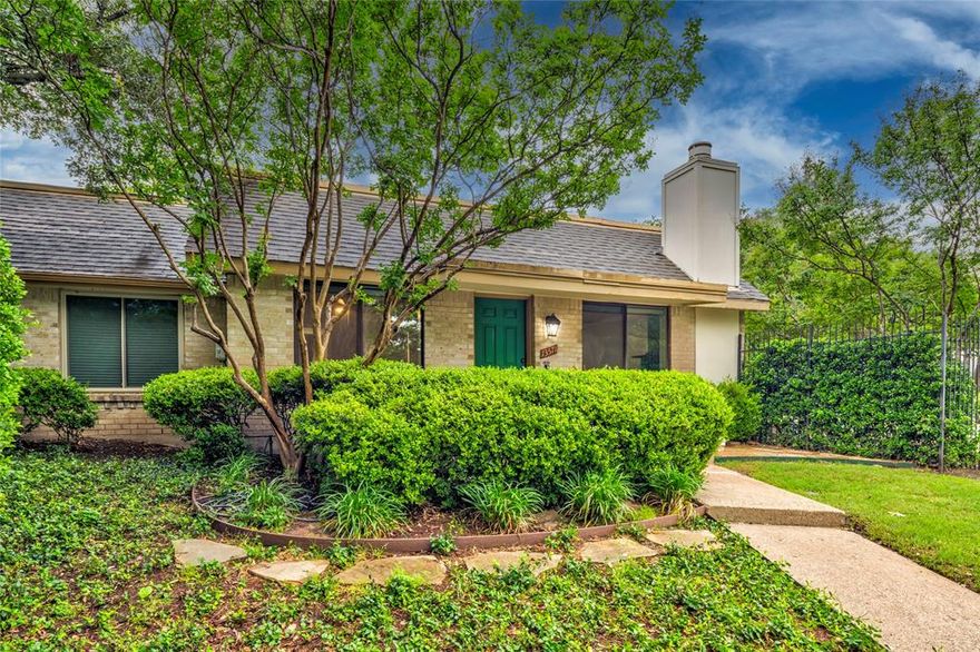 Lovely neighborhood with cozy, tree-lined streets! One story corner unit with windows on three sides for lots of natural light. The spacious living room features a wood-burning fireplace and has a window overlooking the community pool & clubhouse next door. Galley style kitchen with rich stain grade wood cabinets, electric range, dishwasher, & microwave. Large primary bedroom & secondary bedroom. The third bedroom has been converted into a 2nd living-office-dining room with added shelving in closet to serve as a second pantry or extra storage (can easily be converted back to a 3rd bedroom if desired). Slate tile flooring throughout. Dining room overlooks back patio with private fenced courtyard - great for grilling! Since this is an end unit, you have the added advantage of 4 assigned spaces under the carport behind! Move-in ready with 2026 interior paint! Zoned for Richardson ISD!