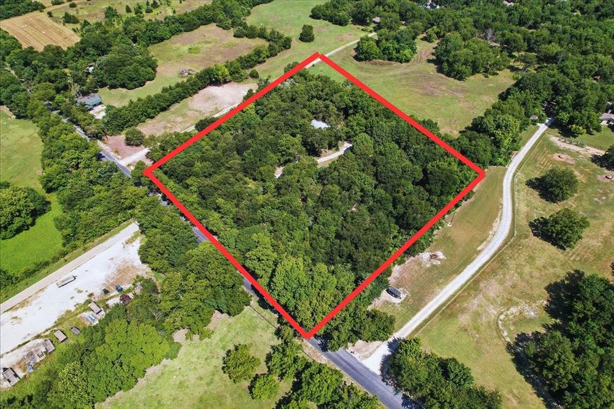 SUPER INVESTMENT OPPORTUNITY in PRIME LOCATION! 
Don’t miss this rare chance to own 3.65 rolling acres in the McKinney ETJ, ideally positioned at the intersection of McKinney, Fairview, and Lowry Crossing in Collin County. Located outside city limits, this unrestricted land offers endless possibilities—build your dream home, develop a private estate, or explore investment and development potential.
The property is a secluded, tree-covered retreat featuring mature Oak, Elm, and Black Walnut trees and boasts over 400 feet of road frontage. Utilities are already in place, making it ready for your vision.
 A well-maintained manufactured home currently sits on the property, complete with porches and a carport, perfectly positioned to enjoy views of the beautiful wooded terrain.
Just 5–10 minutes from Stacy Road, Hwy 75, and downtown McKinney, you’ll enjoy both privacy and convenience.
No HOA. No city taxes. Endless potential. Bring your ideas and make this slice of North Texas your own!