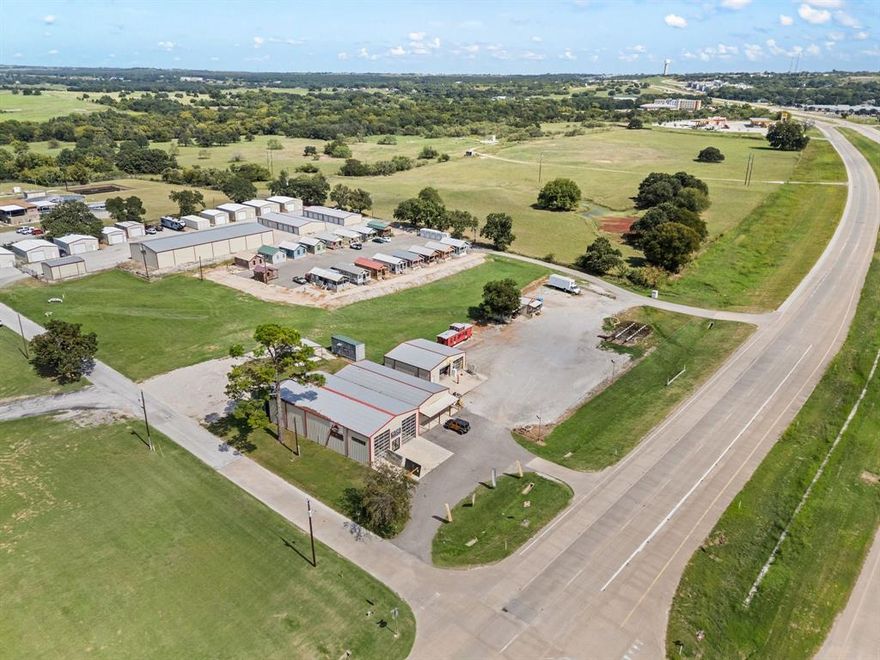 CALLING ALL INVESTORS AND DEVELOPERS!!! Outstanding opportunity to own improved, income-producing commercial land with prime US Highway 380 frontage in Decatur, Texas. Currently generating up to $12,000 in monthly income from 6 tenants, this property offers both immediate cash flow and long-term development potential. Situated just outside the city limits with commercial zoning, the tract delivers flexibility and future growth upside in one of North Texas’ fastest expanding corridors.

The location provides unmatched visibility and accessibility, with high traffic counts along US 380 ensuring maximum exposure. Decatur continues to experience significant residential and commercial expansion, making this site an attractive investment for developers, land bankers, and value-driven investors alike. 

This property’s strategic placement and built-in income stream create a unique blend of current yield and future upside. Ideal for retail, mixed-use, office, or investment-grade projects, the land is positioned to capture daily commuter traffic, local residents, and regional travelers while benefiting from Wise County’s continued population growth and economic momentum. Wise County is the current stop for national developers and local!

**Key Highlights:**

* Income-producing land: up to $12,000 monthly from 6 tenants
* US 380 highway frontage with excellent visibility
* High traffic counts for maximum exposure
* Outside city limits and zoned commercial
* Flexible future use potential: retail, mixed-use, office, or investment

Bring your vision and secure a property that delivers both immediate return and long-term opportunity in one of North Texas’ most dynamic growth markets.  New Asphalt installed with acceptable offer. Aerial imagery is for illustration only. Property boundaries and acreage (approx. 2.18 acres) subject to survey. Sales price is not contingent on exact land size. Property to be sold by metes and bounds description.