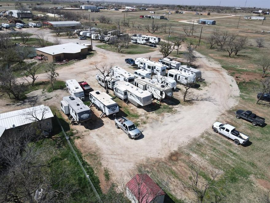 Front Porch RV Park offers an exciting opportunity to own a thriving property with room to grow, perfectly positioned along the highly traveled I-20 corridor in Merkel, Texas. Spanning nearly 12 acres, this inviting destination features 40+ established RV sites with ample space to expand and add even more income-producing spots. The property is thoughtfully equipped with a 960 sq ft office space for operations, a spacious three-sided metal structure ideal for gatherings and events, and a refreshing pool with a large concrete patio that creates a welcoming atmosphere for guests to relax and connect. Additional improvements include a 500 sq ft shop for storage or maintenance, a substantial 2,312 sq ft building formerly operated as a restaurant offering excellent potential for a café, store, or entertainment venue, and a comfortable 1,024 sq ft home on site. With excellent visibility, versatile improvements, and significant expansion potential, Front Porch RV Park blends charm, functionality, and opportunity into one dynamic investment.