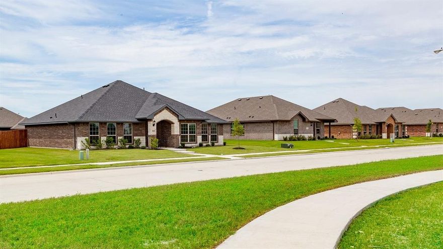 MLS# 21272516 - Built by Camden Homes LLC - May 2026 completion! ~ Traditional single-family residence in Camden Park Estates offering 1,627 sq ft, 3 primary bedrooms and 2 full baths. Open interior with luxury vinyl plank flooring, granite counters, pantry and walk-in closet(s). ENERGY STAR central heating and cooling (electric) with ceiling fans, slab foundation and composition roof. Two-car garage, rain gutters. Construction incomplete; estimated completion 05-31-2026. Waxahachie ISD — Oliver Clift Elementary; Waxahachie High School.