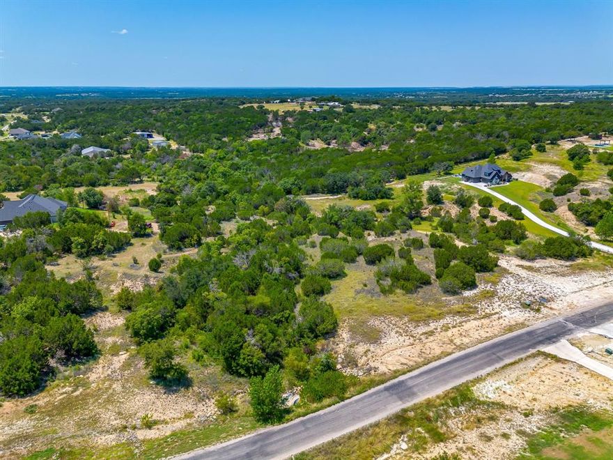 Welcome to your dream homesite in the highly desired Eagles Bluff gated community! Nestled 4.247 acres, this property offers the perfect blend of peace, privacy, and natural beauty being back up to a creek!. Enjoy breathtaking views of the rolling Texas hills and mature and heavily treed topography. Located in a great spot within the neighborhood, you’ll appreciate the quiet atmosphere while still being part of an active, friendly community. Shops are allowed, giving you the flexibility to create the space you need for hobbies or storage. While larger animals are permitted on parcels over 4 acres, you’ll still have plenty of room to enjoy the outdoors with both shop and pool opportunities! Families will love being in a top-rated school district, making this an ideal place to build your forever home. The property requires a well and septic system, giving you the opportunity to design your utilities to suit your needs. Bring your own custom builder. SF minimums apply. Deed restrictions available. Experience the best of Texas living—peace, tranquility, and a welcoming community—all within Eagles Bluff!
