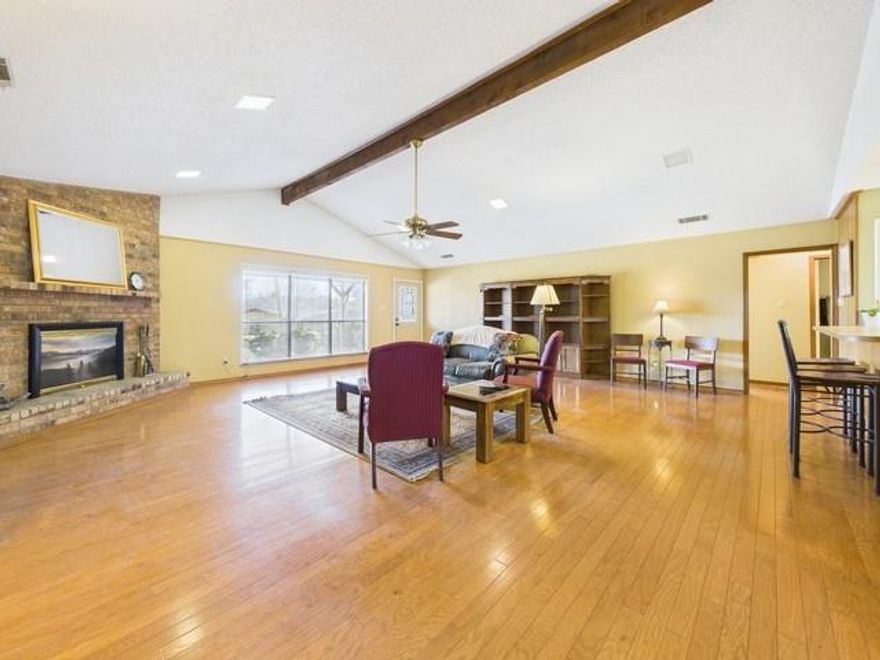 Tucked beneath a canopy of mature trees in the heart of Enchanted Oaks, this 3-bedroom, 2,220-square-foot home offers the perfect blend of lake-life living, privacy, & small-town charm, just steps from Cedar Creek Lake. Situated on 2 wooded corner lots, directly across from the lake, the home enjoys a peaceful setting with scenic views & excellent outdoor space. A covered front porch provides relaxing lake glimpses, ideal for morning coffee or evening unwinding. Inside, the main living area features cathedral vaulted ceilings, wood floors, & a brick wood-burning fireplace, creating a warm & inviting great room filled with natural light. The bright white kitchen offers plentiful cabinetry, generous counter space, & stainless steel appliances, making it well-suited for entertaining or everyday living. A flex room currently staged as a third bedroom, offers versatility for buyers seeking a home office, guest room, game room, or additional sleeping space. Floor-to-ceiling windows in the multi-use area flood the space with natural light & enhance the open, airy feel. Additional highlights include a two-car garage, circle drive, ample parking, separate storage building & RV parking with electrical hookup, ideal for lake guests, recreational vehicles, or extra storage. Residents of Enchanted Oaks enjoy access to a community pool, children’s park, sports fields, walking & jogging trails, & 2 nearby boat launches, making lake access easy & spontaneous. Whether you’re searching for a primary residence, weekend lake house, or short-term rental, VRBO-ready investment, this home delivers exceptional flexibility. Furnishings may convey, allowing for a seamless move-in or turnkey opportunity. Recently price-adjusted, this property presents outstanding value in one of Cedar Creek Lake’s most charming communities, where comfort, convenience, & lake living come together.