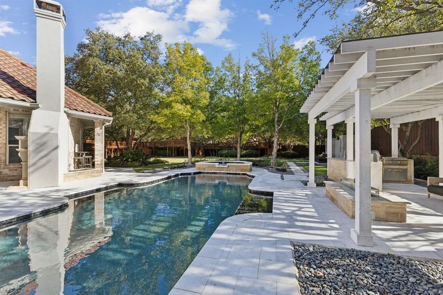 Adventure and entertaining await in this incredible luxury home in West Plano. Welcome to this stunning 4-bedroom, 4.5-bathroom home situated within the incredible and unique Shoal Creek neighborhood known for its mature trees and large lots. Set on a generous .68-acres, this home has the largest lot in the neighborhood currently on the market. Feel at home in the spacious family room with plenty of space for large gatherings with a two story ceiling and gas fireplace. The chef’s kitchen boasts premium appliances, including a Sub-Zero refrigerator, Thermador gas cooktop and double oven, quartz countertops, a walk in pantry, second sink and ample storage in the island. The primary suite is a true retreat with a spa inspired bathroom with rainfall shower and body sprayers, two closets and soaking tub. The home also includes a private office with built in executive desk and shelving, a warm den adorned with fireplace and additional built ins, a game room, and a fully-equipped media room. A spacious three-car garage provides plenty of parking with extended driveway. Paradise awaits in this backyard. The focal point is a newly renovated pool and spa with marble tile surround embraced by lush landscaping that creates a resort-like atmosphere. A fully equipped outdoor kitchen, fireplace and pergola with a built in gas fire pit set the perfect scene for memorable gatherings. A highlight of this property is the custom-built treehouse, added in 2019. With four hideout rooms and multiple access points, this unique treehouse provides an enchanting experience for children or anyone in search of adventure and fun.The expansive open grass space offers limitless possibilities for recreation and relaxation. Additional features include a whole home water purification system, UV air purification system, tankless water heaters, and all HVAC systems replaced in 2022. Entire home including all lights, plugs, pool and spa, water features and more can be controlled by your phone or device.