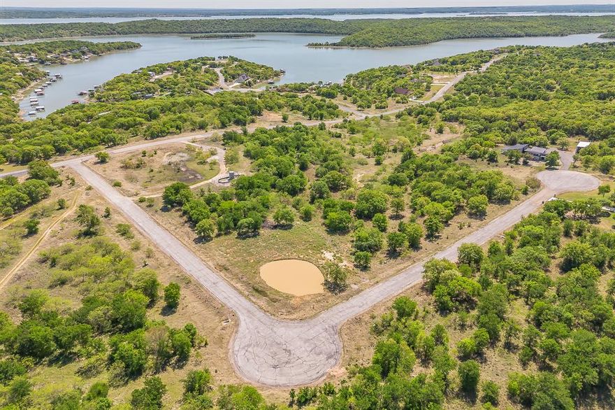 Beautiful Corner Lot in North Star Pointe on Lake Bridgeport- This one-of-a-kind 1.55-acre lot in the exclusive gated lakeside community of North Star Pointe is the ideal place to build your dream home. Perfectly positioned on a quiet cul-de-sac and a corner lot, the property features a private pond—ready to be stocked with fish or transformed with a stunning fountain to create your own peaceful retreat. The lot has already been cleared, with some dirt work completed, offering a head start on your build. Just around the corner, you’ll find easy access to the lake and the community’s private amenities, including a pool, pickleball court, and boat ramp with slips.  This property is ready for you to start planning your lakeside lifestyle.
