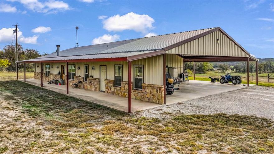 Authentic ranch living meets modern comfort in this 4-bedroom, 2.5-bath barndominium set on 17.8± unrestricted acres in Parker County. Stained concrete floors paired with custom wood and rock work anchor the open-concept living area, creating a true Western feel. The kitchen is built for everyday use, featuring a large island, abundant storage, and thoughtful functional design. The primary suite offers a private en-suite bath, while the additional bedrooms provide plenty of space for family or guests. Outside, the land is ready for your livestock, horses, or equipment with a versatile shop, covered awning, and a dedicated riding pad for your equestrian needs. Wide-open acreage offers room to roam and ride. Located just minutes from Weatherford’s dining, shopping, and entertainment, this property delivers the peace of country living without sacrificing convenience. A rare opportunity to own a functional, country estate in a highly desirable area.
