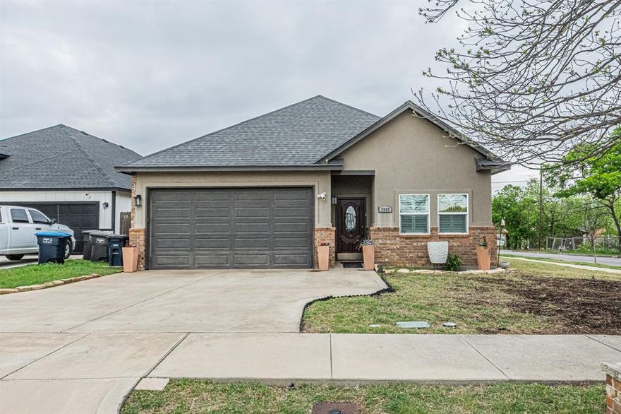 Charming open-concept home on a desirable corner lot in Fort Worth. Features include hardwood floors, granite countertops, and a decorative fireplace in the main living area. Open concept, split bedroom, spacious primary suite offers a large walk-in closet. Laundry room includes built-in sink for added convenience. Great layout for everyday living and entertaining.
