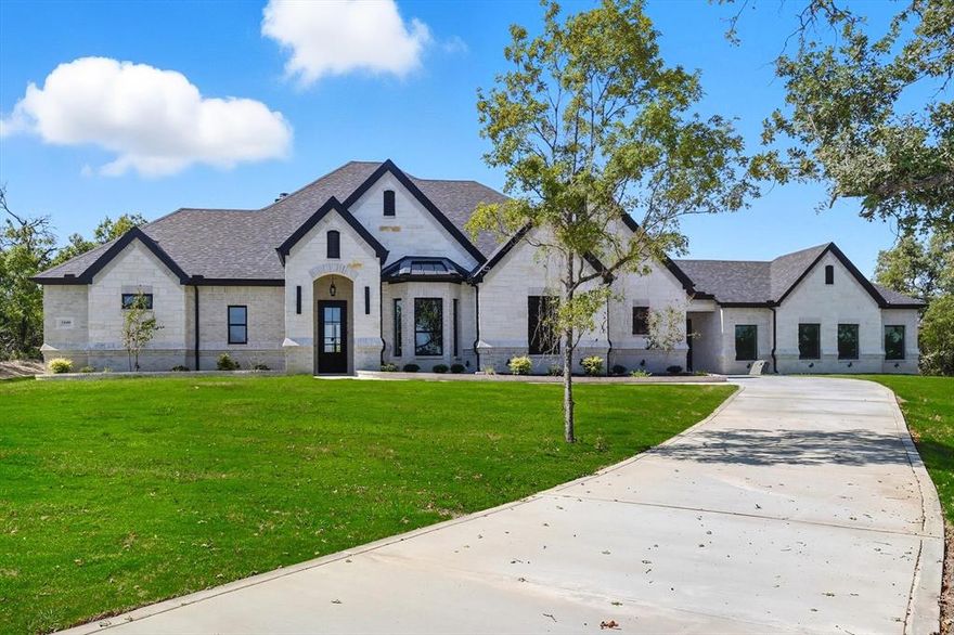 Beautiful 2-acre property featuring 5 bedrooms, private office, and upstairs game room. Chef’s kitchen with custom ceiling-height cabinetry, premium appliances, and open living area with fireplace. Outdoor spaces include an oversized balcony, full outdoor kitchen, and additional fireplace. Foam insulation, propane tank, water well, and no city taxes provide comfort and savings. $10,000 seller credit offered!