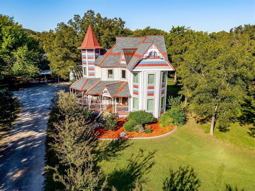 Experience modern function and the grandeur of a Victorian era residence in this modern built example of turn of the century elegance. Intricate woodwork, rich wood floors, and custom ceilings adorn the interior of this home and create exceptional living spaces. The heart of the home is the gourmet kitchen which is perfect for culinary enthusiasts featuring a large island, butler's pantry and commercial grade appliances. The stunning staircase leads to a gallery above overlooking the grand great room with built in cabinets, an exceptionally appointed fireplace and a soothing saltwater aquarium. The guest house, complete with a full kitchen, bathroom and bar, is ideal for hosting social events or overnight guests. Relax on the large wrap around porch, featuring Brazilian Cherry wood, and the nearby garden sitting area, or explore the lush grounds, featuring mature trees and a tranquil pond. A large insulated shop with commercial-grade fans is perfect for RV or boat storage. Multicolored fish scale siding and roofing and an asphalt driveway running past the pond and windmill speak to the details which make this property unique among all houses in the Dallas and Fort Worth metroplex. No expense was spared when constructing this magnificent estate. If you value quality workmanship, intricate style and unsurpassed character, come home today!