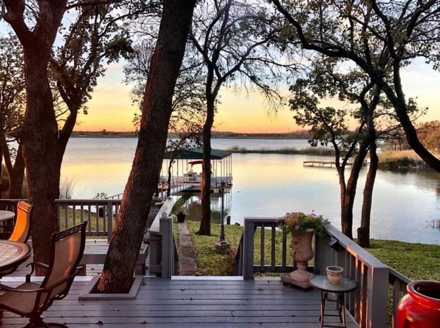 Lakefront living at its finest on beautiful Lake Graham. This move-in-ready 3-bedroom, 3-bath home offers stunning water views and exceptional outdoor entertaining space just in time for lake season.

The thoughtfully designed layout features two spacious living areas, a dedicated office space, and a large pantry, offering flexibility for both full-time living or a weekend lake retreat. The updated kitchen includes modern appliances and opens to comfortable gathering areas perfect for hosting family and friends.

Step outside to a massive back deck and concrete patio with hot tub and party lighting overlooking the water, an ideal setting for relaxing evenings and lakeside entertaining.

The property is built for both enjoyment and durability with fiberglass siding designed for long-term performance and reduced exterior maintenance. The composite dock provides a splinter-free, rot-resistant surface for years of lake use and includes a three-Jet Ski EZ Dock system.

Additional improvements include a fully enclosed RV-boat barn with high clearance, detached two-car garage, separate storage building, and a lakeside sprinkler system supported by an underwater lake pump to maintain the manicured landscape.

A Norweco Singulair wastewater treatment system provides efficient, modern wastewater management.

Located in Graham, TX, this property offers the tranquility of lakefront living while still enjoying the conveniences of the growing Graham community with restaurants, shopping, and local amenities nearby.