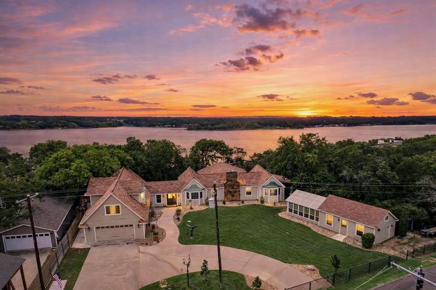 Stunning Lake Worth waterfront estate ready for a new owner to love and enjoy this spring and summer! This remarkable property spans just over an acre and lies adjacent to city property which will remain preserved wildlife as you see it. Careful attention to detail was used when the home was remodeled in 2016 to preserve the original charm while blending modern day construction standards. Entertainers delight this home features incredible gathering space inside or outside on the covered and uncovered patio's spanning 90' along the back of the home. Whether you are hosting a dinner party or enjoying your morning coffee on the patio soaking up the breathtaking views, the tranquility of the wind blowing through the mature trees and exquisite landscaping overlooking the lake in will make you never want to leave. This home is truly its own private sanctuary.  Enjoy the ability to quickly cruise the lake from your very own private dock complete with a 10k boat lift and some of the deepest water in the lake right at the edge of your dock! Lake Worth is a special find with low boat traffic and a somewhat stable lake level even throughout drier months.  At the heart of the home lies the family den where the owners love too spend their mornings and afternoons enjoying the views. Downstairs you will find the primary bedroom, gourmet chef's kitchen, and office with views that truly make it hard to work! Upstairs lies 2 guest bedrooms, full bathroom with clawfoot tub, and a secondary living space. When it is time to retire for the evening the downstairs living room provides the perfect setting for an evening fire while overlooking the lake!  Fully climate controlled work shop attached to the spectacular 300sqft green house! 12x16 she shed near the waters edge has endless opportunities and plenty of charm with the shiplap ceiling and walls. Additional dock features include enclosed storage space, sink, and fridge with water line for water and ice!  LAKE LIFE IS THE BEST LIFE!!