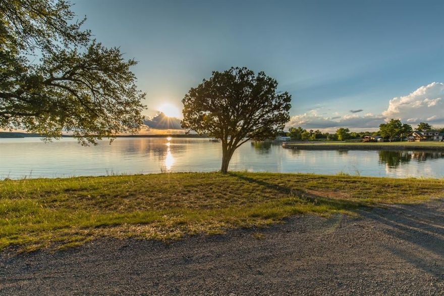 Updated and furnished lake home with sweeping, wide-open views of Possum Kingdom Lake! Ideally situated in the heart of Golden Cove—within easy walking distance to the community boat ramp and swim cove—this prime location lets you soak in lake living from sunrise to breathtaking sunsets, all from a spacious, grassy front yard.

Golden Cove offers a true sense of community along with excellent amenities, including access to the swim cove, boat ramp, community dock, pavilion, and neighborhood events that make lake life even more enjoyable.

After a full day on the water, retreat to this cozy and well-maintained home featuring an open-concept living and kitchen area, an inviting enclosed sunroom, and four bedrooms, with room for a large family or plenty of guests. Out back, you’ll find a shaded oasis beneath a majestic oak tree—perfect for grilling, relaxing, and entertaining—fully enclosed by a wooden privacy fence. A newly added (2024) carport provides two covered parking spaces for vehicles or your boat.

The sellers have lovingly cared for this property, painting the exterior and making plumbing improvements in recent years. This is leased land with a current monthly lease fee of $915; the landowner pays the lot taxes. Deeded properties with views like this at Possum Kingdom Lake are increasingly rare and typically come with a much higher price tag.

Come see it for yourself and get into your own lake place before Spring Break!