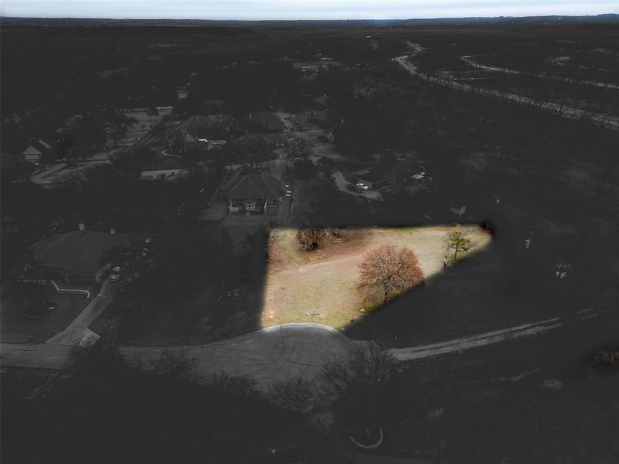 Welcome to Pecan Plantation, LOT 1328, 9705 Ravenna Ct, 18,349 sqft (0.42 acre) Located on a Cul de sac off Ravenswood in Unit 15.  Beautiful lot. Perfect setting for those that desire more privacy and space. LOT measures approx 61 x 137 x 175 x 180. Site is complete with asphalt road, electric service, MUD water, requires a septic system. Min SQFT to build is 1,200. plenty of room on LOT with a 15’ front building setback line instead of the usual 25’.   Side building setback lines are 7’ and rear is 5’. No time frame to build and you may use any builder. Discover the exceptional lifestyle of Pecan Plantation, a private, gated community nestled along 17 miles of the historic Brazos River within a 4,200 acre pecan orchard. Enjoy resort style amenities including two championship golf courses with full practice facilities, a full-service clubhouse with multiple dining options, marina with access to Lake Granbury, tennis & pickleball courts, pools, dog park, riverside parks, Airparks, camping, & 24 7 security with Fire & EMS services. The Village, features a bank, grocery store, restaurant, Pecan Medical Clinic, PT Services, pharmacy, golf cart shop, Vet Clinic, car wash, & Ace Hardware. Just minutes from the Historic Granbury Square officially the “Celebration Capital of Texas” under an hour from Fort Worth. Experience the perfect blend of tranquility, recreation, and convenience. Come see why you’ll want to build your dream home here! PPOA Mandatory Membership as of 9-1-25: PPOA Transfer Fee $1,091.00 + 73.65 (tax) = $1,304.49. Initiation Fee $4,381 EQUALS: $5,545.65 The monthly fee is $204.75 and includes trash service or $182.75 without trash service. Search YouTube 'Airplane Ride Around Pecan Plantation Rebecca Van Buren' to learn about our amazing community.