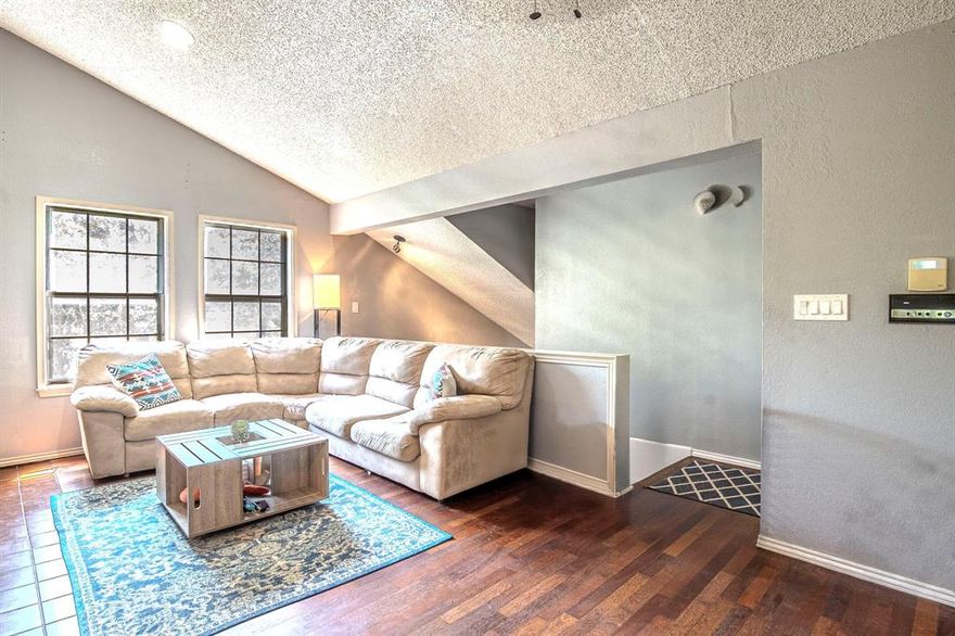 MAJOR PRICE IMPROVEMENT!! Whether you're looking for a one-of-a-kind home or a smart addition to your investment portfolio, this property delivers! HOA confirmed they allow short term rentals of 30 days minumum.  No Daily Rentals allowed. Come and see this unique condo that offers the perfect blend of investment potential and a private, comfortable home. Located in the small, 21-unit Manorhomes of Wimbledon community, this property provides a rare treehouse feel, far from a typical parking lot view. For buyers, the highlight is the versatile third bedroom on the ground floor, created from the one-car garage. With a private entrance and a dedicated parking spot, this flexible space is ideal for a home office, gym, studio, or private guest room. The second level is also a flexible space, featuring an expansive living and dining area with vaulted ceilings and a warm wood-burning fireplace. The kitchen is bright and open, and a serene screened-in balcony offers a peaceful retreat among the trees. The primary suite is a quiet sanctuary with vaulted ceilings and abundant windows, creating a peaceful escape.  For investors, this property offers a clear path to high returns. The ground level bedroom could be easily converted back to garage space to maximize the rental potential. The location is a major asset, with high rental demand driven by its proximity to UTA, major highways, shopping, and dining. There have been NUMEROUS rental inquiries on this listing.  The property's unique features make it highly marketable, and all appliances can convey, reducing initial setup costs.