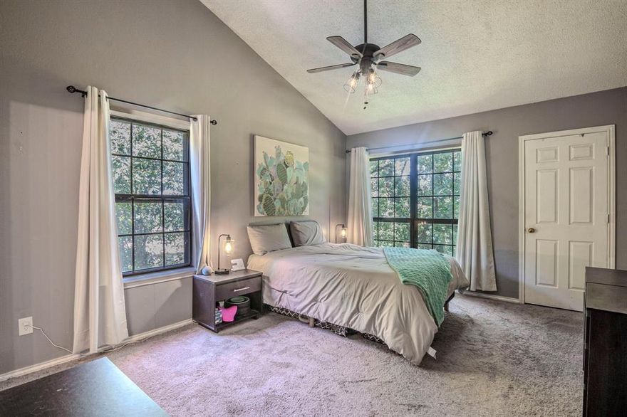 MAJOR PRICE IMPROVEMENT!! Whether you're looking for a one-of-a-kind home or a smart addition to your investment portfolio, this property delivers! HOA confirmed SHORT TERMS RENTAL ALLOWED - 30 days minumum (No Daily Rentals allowed). Come and see this unique condo that offers the perfect blend of investment potential and a private, comfortable home. Located in the small, 21-unit Manorhomes of Wimbledon community, this property provides a rare treehouse feel, far from a typical parking lot view. For buyers, the highlight is the VERSATILE THIRD BEDROOM ON THE GROUND FLOOR created from the one-car garage. With a private entrance and a dedicated parking spot, this flexible space is ideal for a home office, gym, studio, or private guest room. The second level offers a flexible space, featuring an expansive living and dining area with vaulted ceilings and a warm wood-burning fireplace. The kitchen is bright and open, and a serene screened-in balcony offers a peaceful retreat among the trees. The primary suite is a quiet sanctuary with vaulted ceilings and abundant windows, creating a peaceful escape. The secondary bedroom is currently set up as home office space with french doors that open to the dining area. This too could be changed to provide more privacy to that bedroom.  For investors, this property offers a clear path to high returns. The ground level space CAN BE EASILY CONVERTED BACK TO GARAGE SPACE to maximize the rental potential. LOCATION, LOCATION, LOCATION. High rental demand driven by its proximity to UTA, major highways, shopping, and dining. There have been NUMEROUS rental inquiries on this listing.  The property's unique features make it highly marketable, and all appliances can convey, reducing initial setup costs.