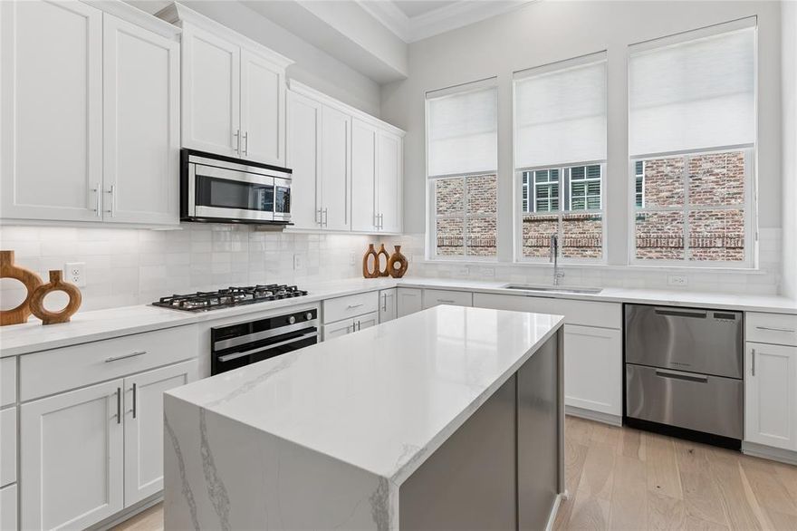 Stunning townhome minutes from Downtown Dallas, Oak Lawn, and the Dallas Medical District. Sophisticated 2-bed, 2.5-bath design by InTown Homes at Cedar Branch features high-end finishes throughout. The open-concept design, 12-foot ceilings, abundant natural light, and striking open staircase dividing the living and dining areas create an impressive sense of space and architectural interest. The gourmet kitchen features a Fisher & Paykel stainless steel appliance package, exquisite quartz countertops, upgraded waterfall island, tile backsplash, and soft-close cabinetry. The primary suite provides an ideal space to unwind, complete with 11-foot ceilings, a spacious walk-in shower, dual vanity, and walk-in closet. Sustainable engineered hardwoods throughout add to the upscale feel of the home, while the 2-car tandem garage provides ample space for parking and additional storage. Enjoy a private rooftop deck with sweeping views stretching from the Dallas Medical District to Downtown Dallas. Community amenities include lush landscaping and a charming resort-style pool. PLEASE GO TO MODEL HOME FOR ALL OPEN HOUSES - 4601 GREENBOROUGH LN.