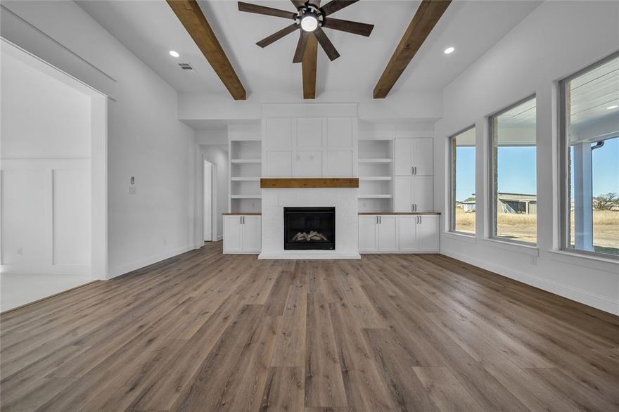 Discover elevated country living in Red Oak, Texas. Situated on over an acre with no HOA, this brand-new custom home offers the perfect balance of luxury, privacy, and wide-open space, all just minutes from Waxahachie, Ovilla, and the DFW Metroplex. Designed with both style and function in mind, this 5-bedroom home features spacious bedrooms with walk-in closets, 2.5 baths, and a light-filled open-concept layout. From the moment you walk in, you’ll notice the attention to detail, including vaulted ceilings with exposed wood beams, expansive energy-efficient windows, and a stunning brick fireplace with custom built-ins that anchors the living space. The chef’s kitchen is built to impress, complete with an oversized island, quartz countertops, soft-close cabinetry, stainless steel appliances, pot filler, and designer lighting. Whether you’re hosting or enjoying a quiet night in, this space was made to bring people together. The primary suite is a true retreat, featuring tray ceilings, warm wood accents, and a spa-inspired ensuite with dual vanities and a large walk-in shower. Secondary bedrooms offer flexibility for guests, a home office, or additional living space to fit your lifestyle. Step outside and enjoy the freedom of over an acre with endless possibilities. Add a pool, build a shop, start a garden, or simply enjoy the peaceful surroundings. Conveniently located with easy access to I-35, shopping, dining, and highly rated schools.