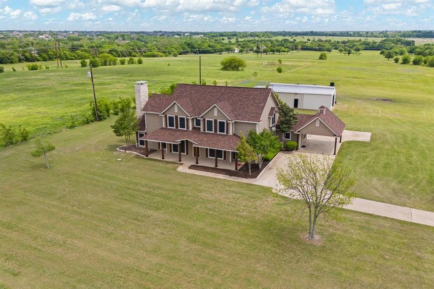 Beautifully crafted 12.51 acre estate offering timeless charm, thoughtful upgrades, and incredible flexibility.  
The heart of the property is a 3,522 sq ft custom home w engineered hardwoods featuring 4 beds, 4 full baths -each bedroom has its own- formal dining, dedicated office space, kitchen, large utility room, full size bay sink, upper-lower cabinets & ample counter space and an expansive two-story living area anchored by a dramatic Austin stone fireplace, perfect for entertaining or cozy evenings.  Designed for the chef, a commercial-grade kitchen, Imperial 6 gas burner range, 24in griddle and two 36in ovens, a massive commissary, ideal for hosting unforgettable gatherings. The 1st floor primary offers a private fireplace, built in cabinetry perfect for a coffee bar and a newly renovated ensuite bath with a full-size soaking tub, large walk-in shower for spa-like comfort, plus double closets. Not one, but 2 tankless water heaters. Step outside and take in a breathtaking scene...each Spring, the property is blanketed with iconic Texas wildflowers, including bluebonnets & Indian paintbrush that surround the landscape with color and beauty.  Lush Coastal Bermuda pasture, perfect for grazing, recreation, or future expansion. 40 yr high impact fiberglass roof. For the workshop enthusiast, discover your happy place in a 24X60, garage parking, insulated, 12' concrete slab equipped with an air compressor piped with 2 hose reels bolted on its own concrete slab just outside.  Percolating septic, 1500 gallon for room to grow, 500 gallon owned & buried propane tank, RV hookup & Ag Exempt. Unwind on the covered front porch as you take in breathtaking Texas sunsets and watch private planes land at nearby Midway Regional Airport, savor the peaceful sounds of country life under a star-filled sky. Located in the sought-after Midlothian ISD, this one-of-a-kind property blends space, serenity, and lifestyle flexibility & the perfect property for multigenerational living!