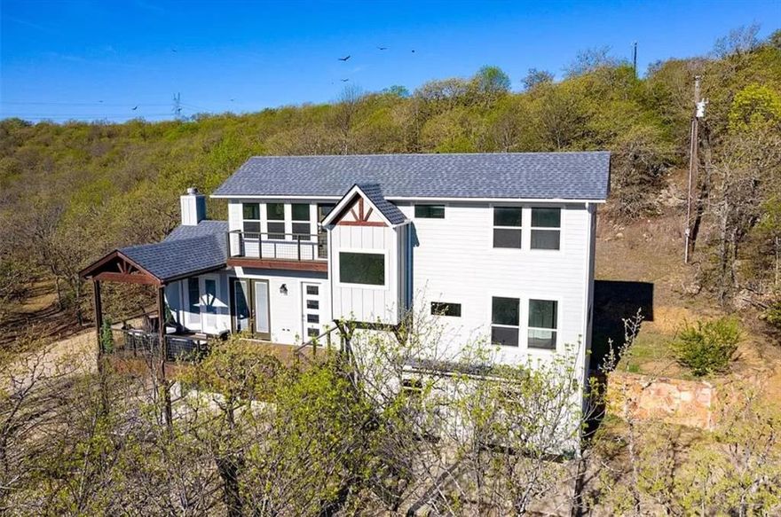 Enjoy stunning Amon Carter Lake views and peaceful sunsets from this 3-parcel hideaway equaling 6-acre. The home showcases a refreshed interior with updated finishes, a roof replaced in 2020, and freshly painted exterior and interior. Light pours in through French doors that open onto a generous covered deck perfect for outdoor living and entertaining.

Inside, you'll find new carpet and an inviting layout, while outside, an oversized tandem garage with two access points provides ample space for vehicles, storage, or equipment. A hilltop yoga platform overlooks both the lake and the home.