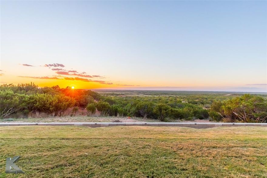 Welcome to your dream retreat—where comfort, craftsmanship, and views come together on over 38 breathtaking acres. Built in 2022, this 2,824 sq ft home offers peaceful privacy just minutes from downtown Abilene. Step inside to an open floorplan with a spacious living area featuring soaring vaulted tongue-&-groove ceilings & a striking double-sided fireplace that warms both the living room & the serene primary suite. Foam insulation, energy-efficient systems, & no HOA add year-round comfort & long-term value. The heart of the home is a stunning kitchen with a large island, custom cabinetry, subway tile backsplash, stainless steel appliances including a gas range, dishwasher, microwave drawer, & a massive walk-in pantry with appliance shelf. Enjoy amazing views from the farmhouse sink, perfectly placed to soak in the scenery. A dry bar with wine fridge and shelving is tucked beneath the stairs—ideal for entertaining. An open staircase leads to a bright loft bonus room offering storage & endless potential. The primary suite includes porch access and a spa-like bath with dual sinks, soaking tub, tiled walk-in shower, and generous storage. Two guest rooms offer ample space, one with porch access and panoramic views. Shiplap accents add charm without overdoing it. Anchoring the backyard is a resort-style pool & spa, perfectly framed by the main home on one side & a multi-functional metal shop on the other. The 1500 sqft shop is fully equipped with electric, a storage loft, & an expansive overhang that faces the pool—ideal for shaded lounging & gatherings. Tucked inside, the finished man cave opens directly to the poolside, creating a seamless indoor-outdoor flow. With ample parking & space to work, play, or unwind, this one-of-a-kind setup is perfect for entertaining, tackling projects, or simply soaking in unforgettable sunsets over the Texas hills—complete with private trails, hunting opportunities, & wide-open freedom that define West Texas living at its finest!