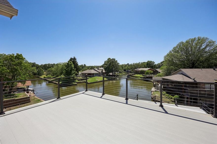 BUILDER OFFERING 2 PERCENT RATE BUY DOWN!!! Luxury Lakefront Living this new custom built all stone exterior smart home sits on a serene protected cove with stunning sunset views. Featuring 3 bedrooms plus an office (or 4th bedroom), a gourmet kitchen inside and out with gas cooktop and gas indoor and outdoor grills, and state of the art technology throughout. Primary suite features ensuite with Jacuzzi soaking tub, steam sauna shower, custom closet, and private deck. Designed for extremely low-maintenance living with a Malarkey 50 year roof, catwalk from back covered porch to large heat-resistant Wahoo aluminum decking on the boathouse party deck upper with boat lift below. Save money watering your lawn with irrigation system lake fed. The list of upgrades is extensive, and truly must be seen to be appreciated. Fall in love with the exceptional quality, thoughtful design, and high end enhancements throughout. Don’t miss this opportunity, luxury convenience to Dallas, and the lake life awaits! VRBO friendly Owner Financing Available for Qualified Buyers or 2 percent rate buy down is being offered.