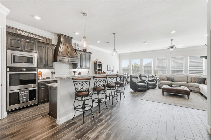 Located on a desirable corner lot in gated Hideaway at Harbor Lakes, this beautifully maintained home combines custom finishes with an unbeatable location. From the moment you step inside, you’ll be welcomed by barrel ceilings with stained wood accents and brushed nickel lighting that create an inviting, upscale feel. The open-concept layout features designer wood-look tile flooring, a glossy subway tile backsplash, and upgraded granite countertops that make the kitchen as stylish as it is functional. Double ovens and a spacious walk-in pantry make entertaining effortless, whether you’re hosting friends or cooking for family. The primary suite offers a serene retreat with stained ceiling beams and a large closet that conveniently connects to the laundry room, a thoughtful design you’ll appreciate every day. Outside, enjoy a fully fenced back yard, the neighborhood’s brand-new pickleball courts and nearby clubhouse, perfect for relaxing, socializing, and staying active. This home delivers the full Harbor Lakes lifestyle. Elegant, easy, and perfectly located.