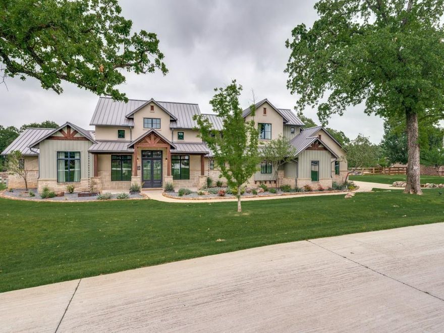 This one’s got the wow factor—inside and out. Sleek, spacious, and full of natural light, this 5-bedroom stunner delivers open-concept living with a modern edge. Dramatic beams, sky-high ceilings, transom windows, and a floor-to-ceiling stone fireplace give the main living area serious style. The kitchen? Total knockout—with a giant quartz island, top-tier Thermador appliances, extra storage, and a walk-in butler’s pantry that feels like its own room. The main-level primary suite is the full package: cathedral ceilings, spa-like bath, massive closet, and bonus space that’s perfect for a workout zone or second office. Two more bedrooms and a flex living room round out the first floor, and there are two more ensuites upstairs. Slide open the massive glass doors and step into your outdoor dream setup: huge covered patio, built-in grill, remote-control screens, and space to build whatever you’ve imagined. Energy-smart with foam insulation, a Class 4 roof, and tankless hot water. No HOA, no city taxes, just next-level living.