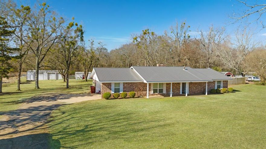 Introducing a beautifully maintained and updated home situated on 1.8 acres in Reno, Texas. This property offers the perfect blend of convenience and privacy, being close to essential amenities while nestled in a tranquil setting.
As you enter this immaculate residence, you are greeted by a spacious living area featuring a striking brick fireplace as the centerpiece. This three-bedroom, two-bathroom home has undergone numerous recent upgrades, including the removal of all paneling, which has been replaced with sheetrock, complemented by crown molding and chair railing. Additional enhancements include fresh paint, new windows, modern cabinets and countertops, updated appliances, a metal roof, new flooring, doors, and extra insulation in the attic. The bathrooms have also been beautifully renovated.
The generously sized bedrooms offer ample closet space, ensuring comfort and convenience. Outdoors, you will discover an expansive front yard and a shaded backyard, complete with additional driveways and parking. The backyard has a fenced area and features an above-ground swimming pool with a spacious wooden deck ideal for sunbathing, entertaining, and relaxation. Furthermore, there is a large 35 x 6 covered front porch, a 30 x 50 three-bay workshop, and a 24 x 30 climate-controlled shop equipped with water and electricity. A sizable fenced area provides a safe space for pets to roam and children to play.
Notable upgrades include an electrical supply enhancement from 100 amps to 200 amps in the house, a replaced air compressor, and all components for both the air conditioning and gas heating systems. Additionally, the large workshop has been upgraded to a new 200-amp service, while the smaller shop has a new 100-amp service.
This beautiful home is move-in ready. Contact your preferred agent for a showing today!