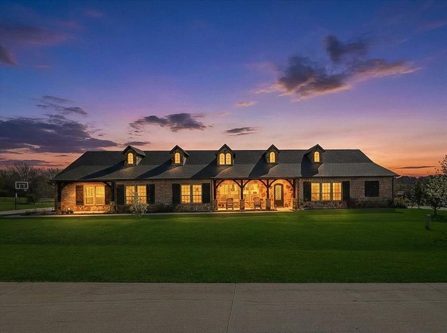 Located within Bella Flora, a prestigious guard-gated community in highly sought-after Aledo ISD, this thoughtfully designed single-story John Askew custom home sits on an expansive 1.27-acre lot, offering a rare combination of privacy, craftsmanship, and resort-style living.
Natural light fills the interior, highlighting the formal dining space and open-concept living area, anchored by a vaulted wood-beamed ceiling, floor-to-ceiling stone fireplace, custom built-ins, and hardwood floors. The chef’s kitchen features top-of-the-line appliances, generous prep space, and seamless flow for both everyday living and entertaining.
A standout feature is the approximately 2,500 sq ft PGA pro-designed golf short game area, complete with Idaho sugar sand bunkers and multiple hitting stations—rarely found in residential properties. Additional highlights include a media room with indoor putting green, high-impact screen, and 4K projector; a versatile gym or flex space; and a private office with separate entrance, paired with adjacent bedroom and bath—ideal for a guest or multigenerational suite, or private work-from-home setup.
The primary suite is tucked away for added privacy and offers a peaceful retreat with fireplace, spa-inspired bath featuring soaking tub, walk-in shower, dual vanities, and separate walk-in closets.
Designed to maximize the setting, the outdoor living space backs to a creek and includes a custom pool, expansive patio, firepit, hot tub, and mature fruit trees—creating a private retreat for entertaining and relaxation.
An oversized three-car garage, prewiring for an automower, and a recently installed Class 4 roof enhance both functionality and long-term value. See documents for additional features, inclusions, disclosures, and floorplan. No survey available.