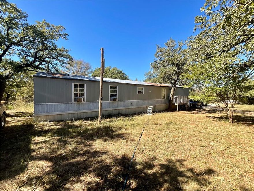 Now available in Millsap.  This 2 bedroom 2 bathroom single wide is nestled on an amazing lot filled with Oak trees.  Located outside the city limits, and with no restrictions, you have complete freedom to make this property your own paradise.  Here you can enjoy the quiet solitude of country living and are only 20 minutes from downtown Weatherford for your shopping and dining needs.