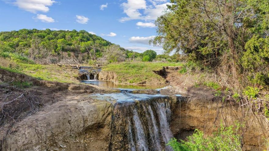 Welcome to Athena Springs Ranch, a true piece of paradise in Bosque County. This 450 acre property is located in the highly desirable Spring Creek area. It boosts 1200 feet of elevation changes from the Spencer Mountain range where many fossils can be found along the mountain top. This property entails a crystal clear 4 acre lake with 2 waterfalls. The most unique feature of Athena Springs ranch is the embedment of what is believed to be dinosaur tracks that can be found in the creek bed! Flowing across the property are the Big Spring and Little Spring creeks which provide the water supply for the lake and ponds on the property. New fences were put in place in 2020 and 2023. Electricity is available in 2 locations along with 3 water wells. Abundance of native game such as Deer, Turkey and Hogs can be found throughout the ranch. There are endless opportunities for this ranch to serve as a family getaway, hunting and fishing retreat, or an income producing ranch.
