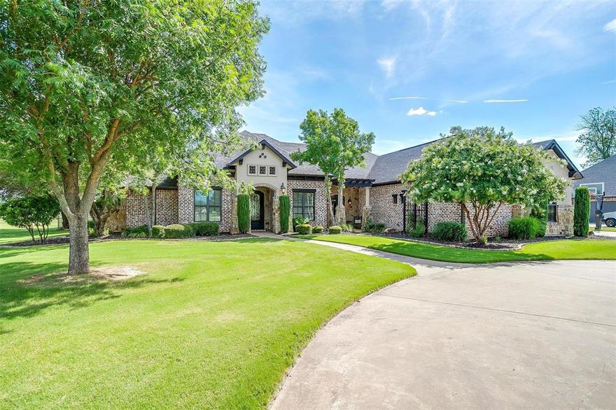 Seller is offering up to $20,000 in buyer concessions for rate buy-down or closing costs with an acceptable offer! Priced well below the recent appraised value, this home offers instant built in equity. Luxurious lakefront living in Granbury’s exclusive Peninsula Community, this beautiful custom-built home is situated on over 3 acres with main body water frontage and includes a private covered dock with boat and dual jet ski lifts. Brand-new full HVAC system with warranty was recently installed and the Class 4 roof is just two years old. Designed for both comfort and entertainment, the thoughtfully crafted floor plan features spacious living areas, large windows and high-end finishes throughout. The open-concept design seamlessly connects the living, dining, and kitchen areas, creating an inviting atmosphere for gatherings. The gourmet kitchen is a chef’s dream, equipped with premium appliances, ample counter space, and custom cabinetry. The spacious primary suite offers a private retreat with separate access to the outdoor patio and pool. With oversized additional bedrooms as well as a loft and bonus upstairs room with an ensuite bathroom, there is plenty of room for family and guests. For ultimate peace of mind, this property includes a 24kW whole-house backup generator, ensuring uninterrupted comfort and security no matter the weather. Step outside to an expansive outdoor living area, where a custom kitchen awaits—fully equipped with a gas grill, Green Egg smoker, and countertop seating. The heated pool and spa is paired with a built-in fire pit and seating. Whether you're hosting a BBQ or watching the sunset, this home is designed for making memories. Additional storage area, ample space to enjoy time by the water, and generous room to build a workshop, RV garage, or custom outbuilding tailored to your needs. This unique property is a rare opportunity to own and experience lakefront living!