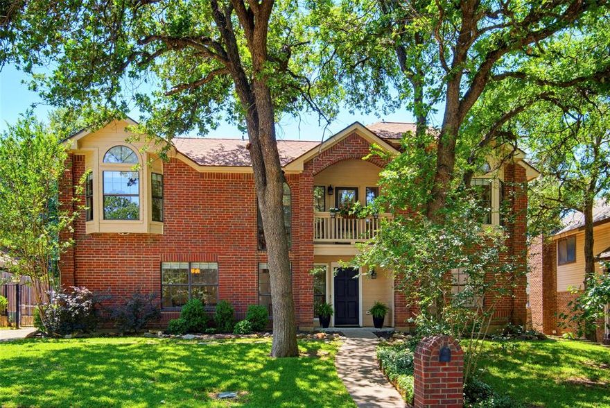 Two blocks to Lake Arlington. Martin High School district. Easy access to I-20 & Highway 287. Two-story brick home sitting elevated on the street. Mature trees anchoring the lot. Traditional architecture with bronze & iron finishes threading throughout, the kind of aesthetic that ages with character instead of chasing trends. Walk in & the great room commands attention. Wood burning fireplace as centerpiece. Wood paneling walls painted but still delivering dimension & depth. Dry bar ready for evening pours. Room flowing naturally into the kitchen, open sightlines without losing definition. Kitchen built for gathering. Custom wood cabinetry. Granite countertops. Stainless appliances. Large layout with breakfast bar doubling as homework island. Space for friends perched with wine while you prep. Dedicated breakfast nook overlooking the mature treed backyard through windows framing green space. Half bath downstairs so guests stay in common zones. Primary suite downstairs. Huge bedroom with vaulted ceilings stretching overhead. Room for seating area if desired. Primary bath with dual sinks. Separate tub & shower. Three bedrooms upstairs. Tall ceilings throughout. Serious storage capacity. Dedicated full bath serving the second floor. Balcony cantilevering over the front door, built for evening air. Systems & infrastructure recently upgraded. Roof replaced. HVAC system replaced. Water heater replaced. Garage doors replaced. Gutters replaced. All window screens replaced, Fiber Optic Installed. The mechanicals handled so you don't have to. Backyard delivers space & shade. Mature trees providing natural canopy. Patio shaded by established growth. Shed handling tools, storage, overflow. Room to breathe. Shorewood Estates positioning. Two blocks to Park & Lake Arlington for trails, water access, green space. Martin HS district. I-20 & 287 connecting Fort Worth, Dallas, Mid-Cities. Traditional layout with finishes that hold. Lake proximity. Arlington address with space.